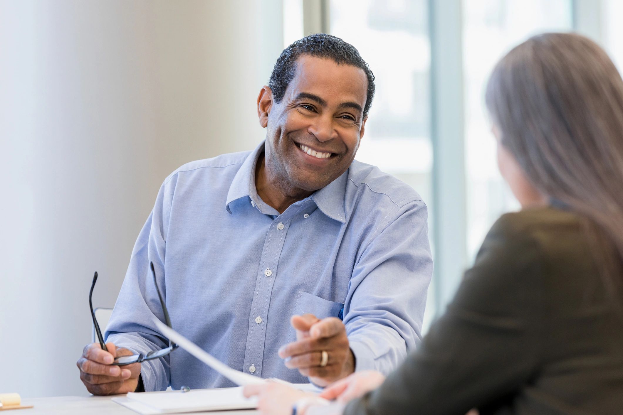 Smiling adult in a supportive conversation
