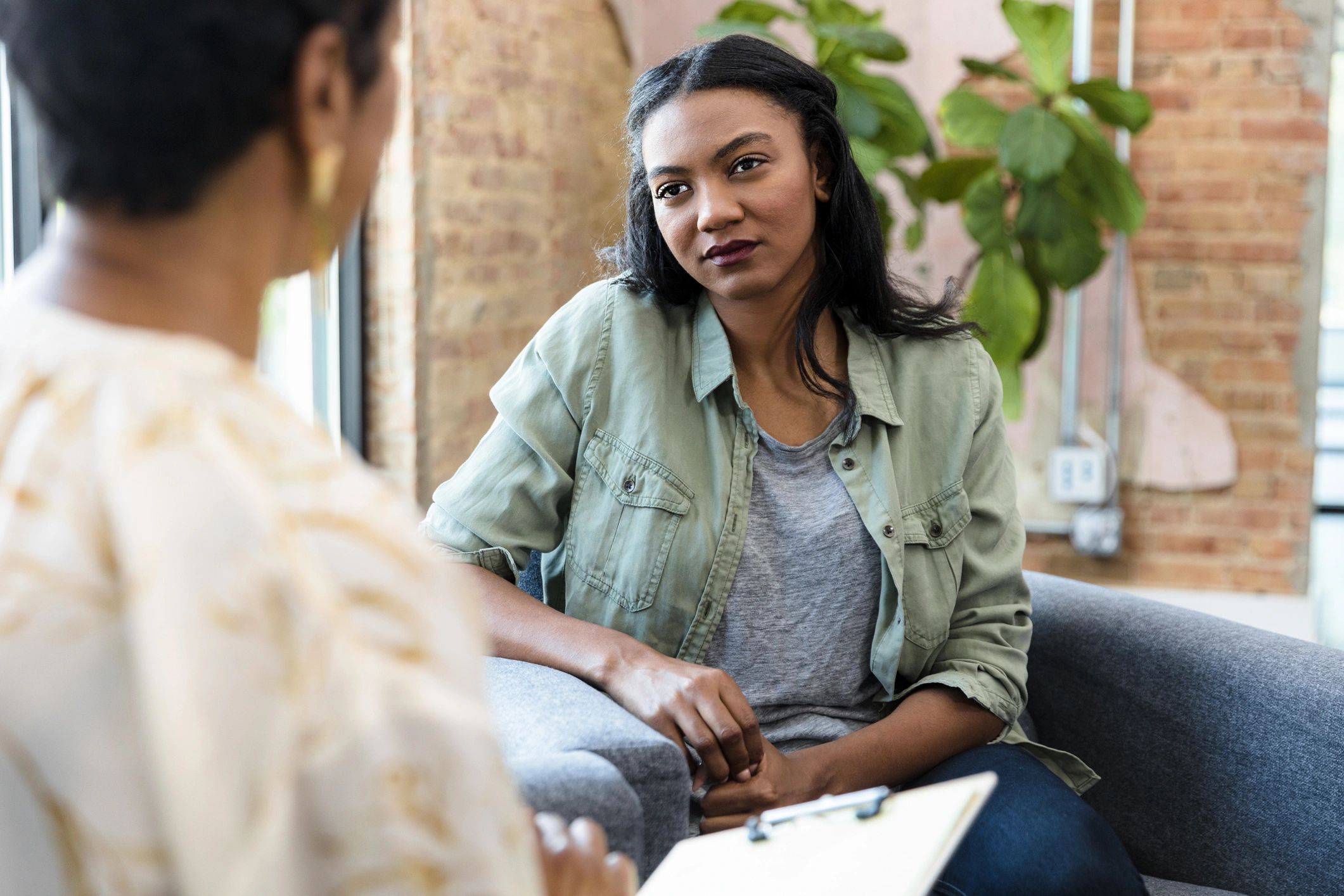 Counselor speaking with a young woman in a supportive setting