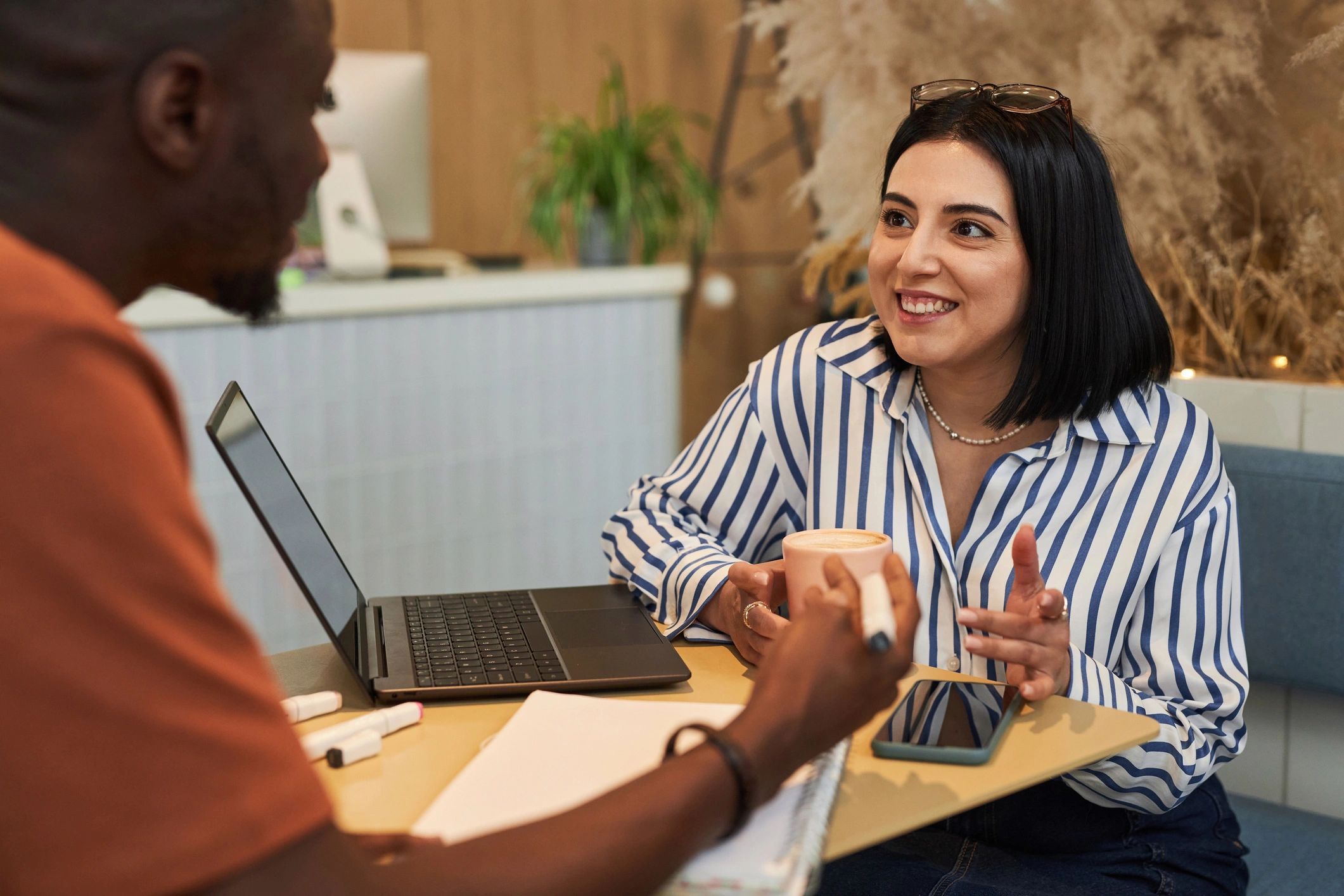 Two people in a supportive conversation at a table