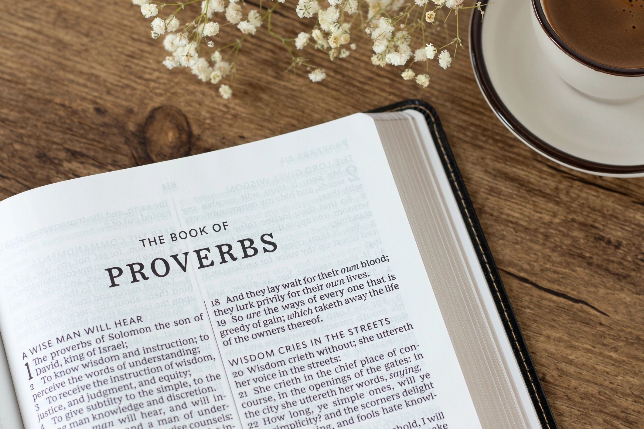 Open Bible with coffee on a desk