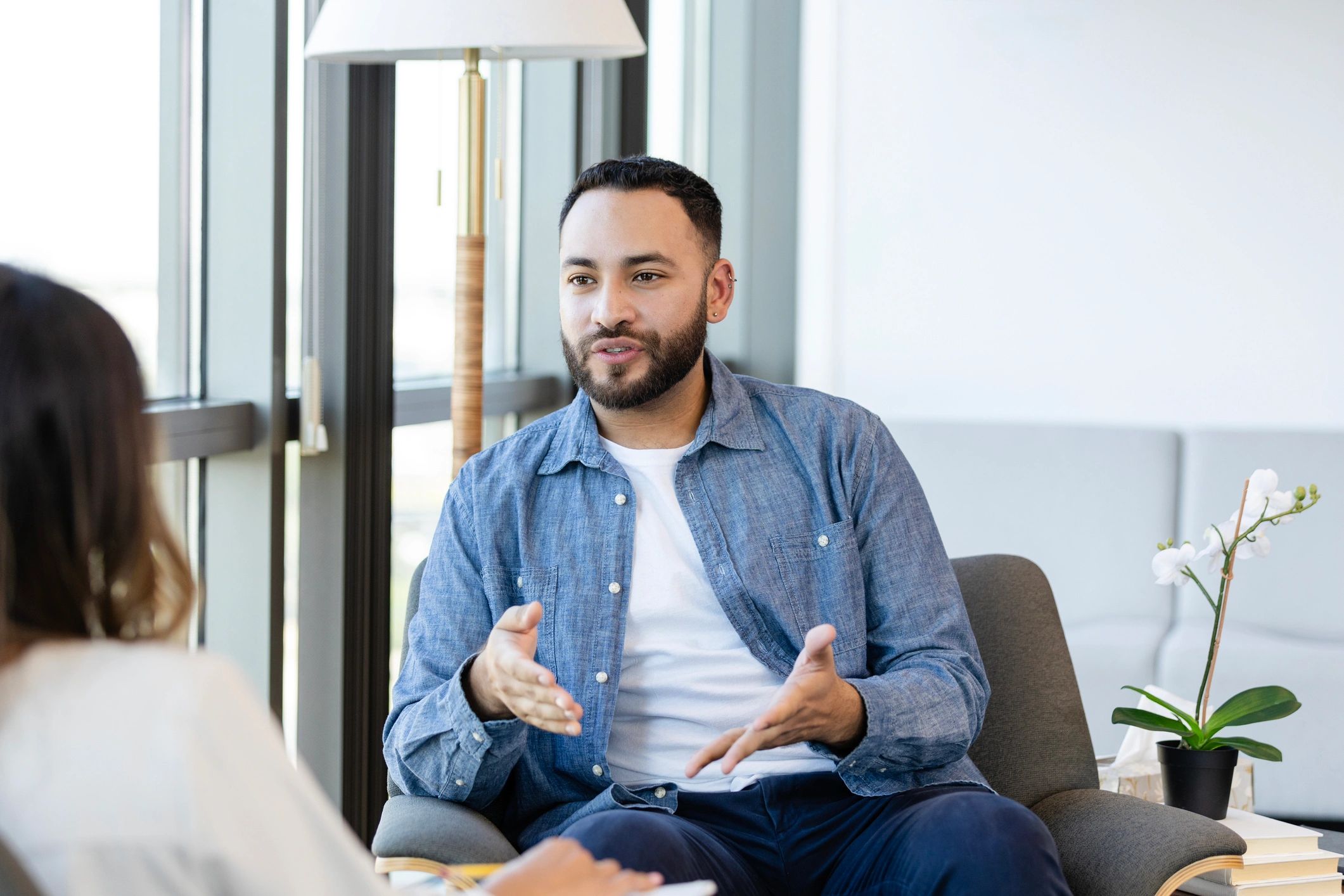Two people in a supportive conversation during a counseling session
